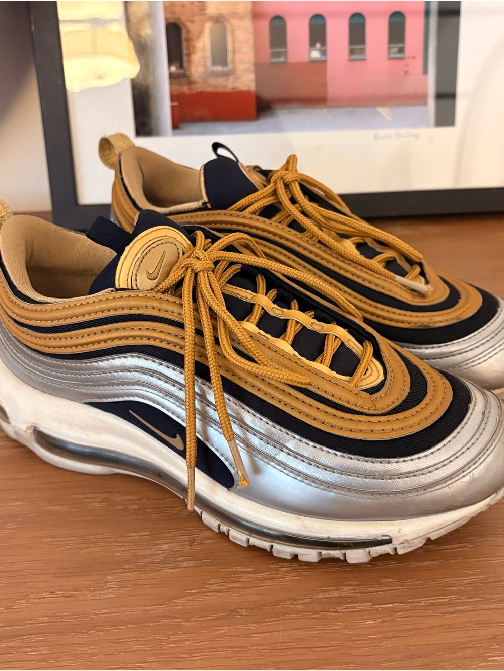 Nike sneakers in gold and black with white label